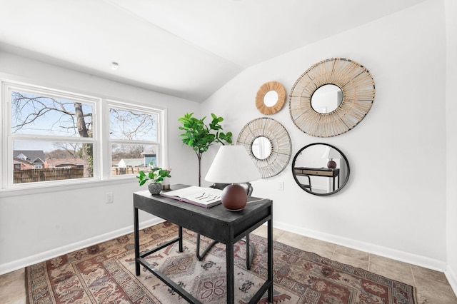 tiled home office featuring baseboards and vaulted ceiling