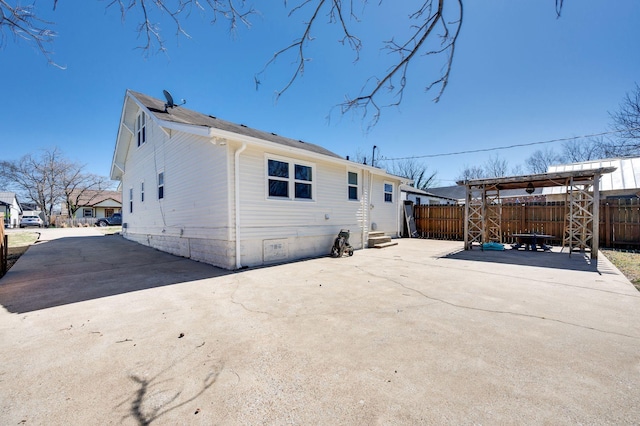 back of property featuring a patio area and fence