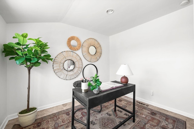 office area featuring vaulted ceiling and baseboards