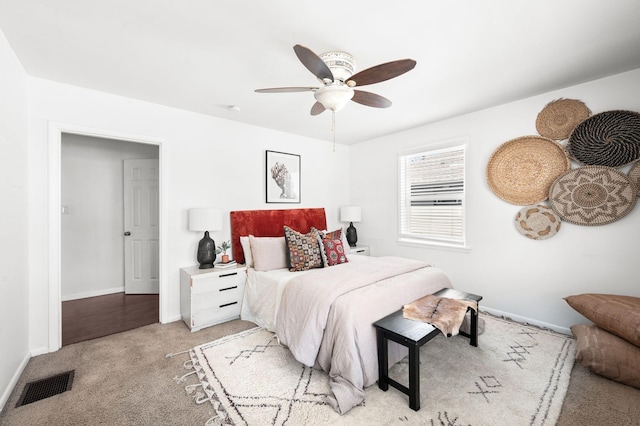 bedroom featuring visible vents, light carpet, baseboards, and ceiling fan