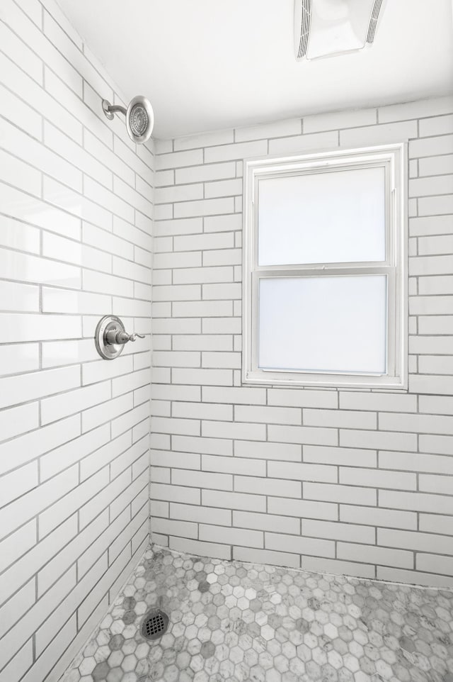 bathroom featuring visible vents and tiled shower