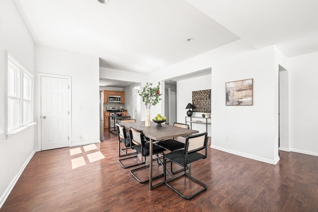 dining room featuring dark wood finished floors and baseboards