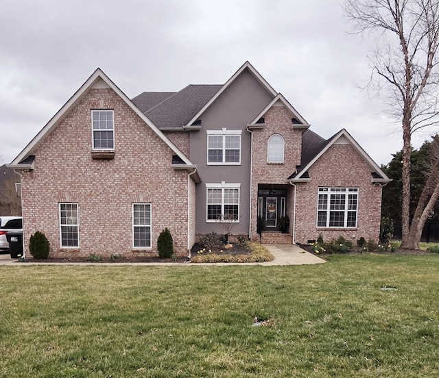 traditional-style home featuring brick siding and a front lawn