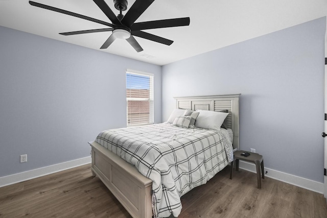 bedroom featuring visible vents, baseboards, and wood finished floors