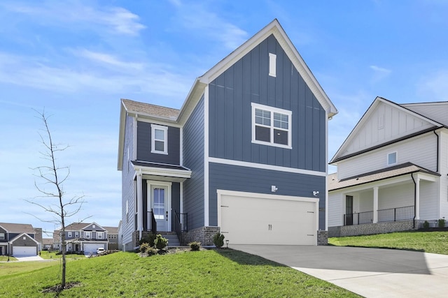 view of front of property with a front lawn, a garage, board and batten siding, and driveway
