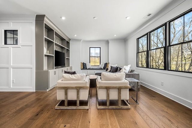 living room with baseboards, visible vents, recessed lighting, dark wood-type flooring, and crown molding