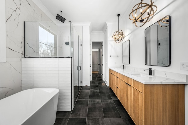 bathroom with a soaking tub, double vanity, a stall shower, a sink, and a notable chandelier