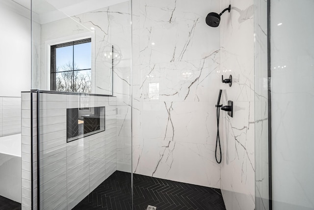 bathroom featuring a marble finish shower