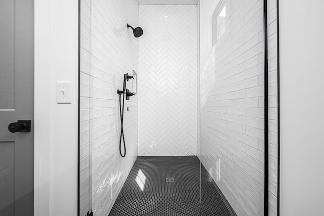 bathroom with a tile shower