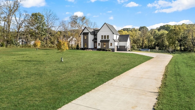 modern farmhouse style home featuring an attached garage, concrete driveway, and a front yard