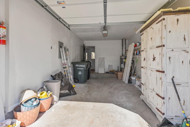 garage featuring electric water heater and a garage door opener