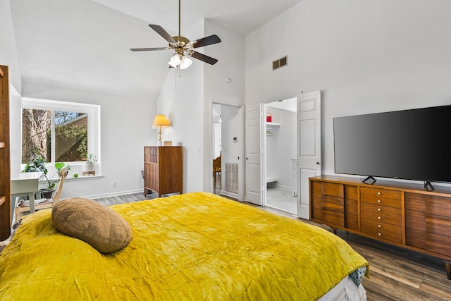 bedroom with visible vents, ceiling fan, baseboards, high vaulted ceiling, and dark wood-style flooring