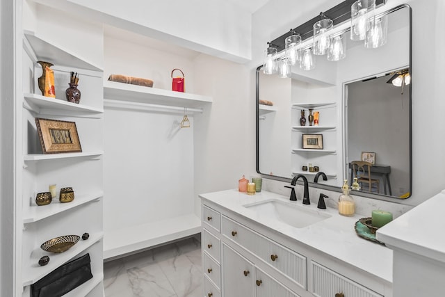 full bathroom featuring marble finish floor and vanity