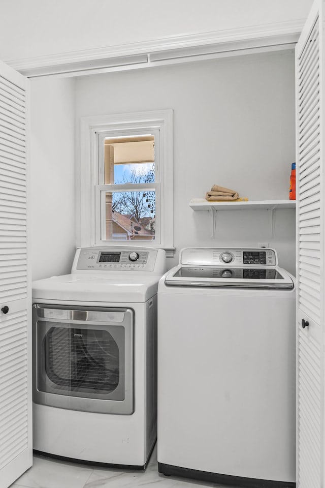 laundry room with marble finish floor, laundry area, and washing machine and clothes dryer