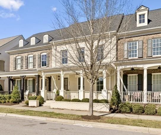 townhome / multi-family property featuring a porch