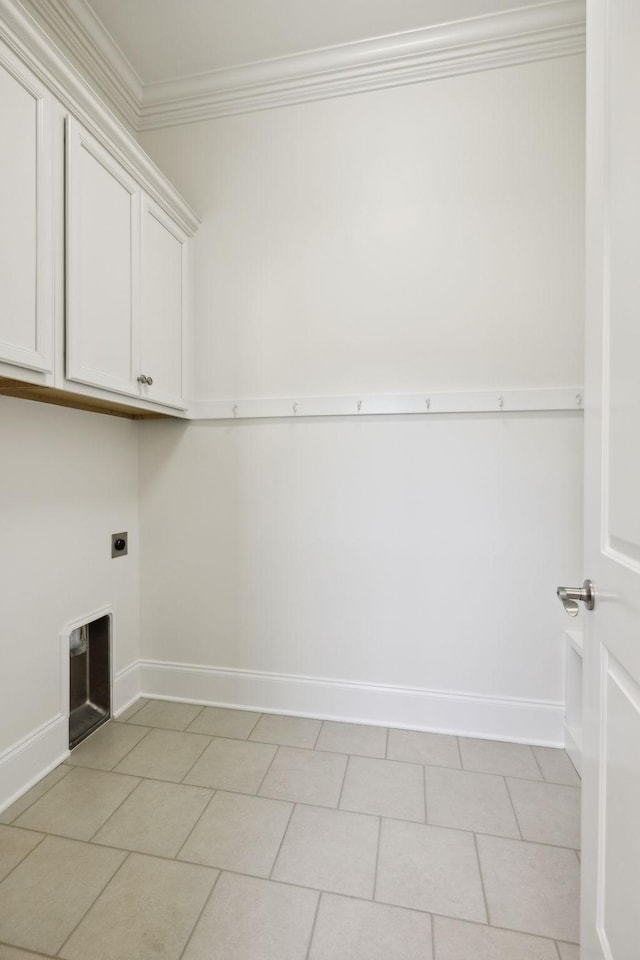 laundry area featuring light tile patterned flooring, cabinet space, electric dryer hookup, and crown molding