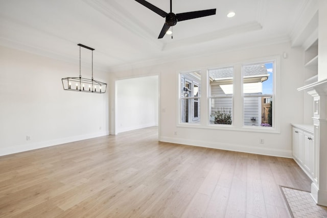 unfurnished living room with baseboards, light wood finished floors, a tray ceiling, crown molding, and ceiling fan with notable chandelier