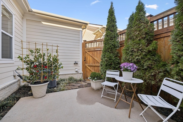 view of patio featuring a gate and fence