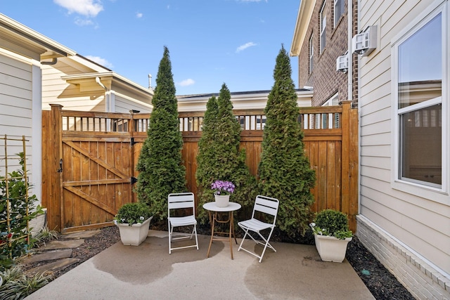 view of patio featuring a gate and fence