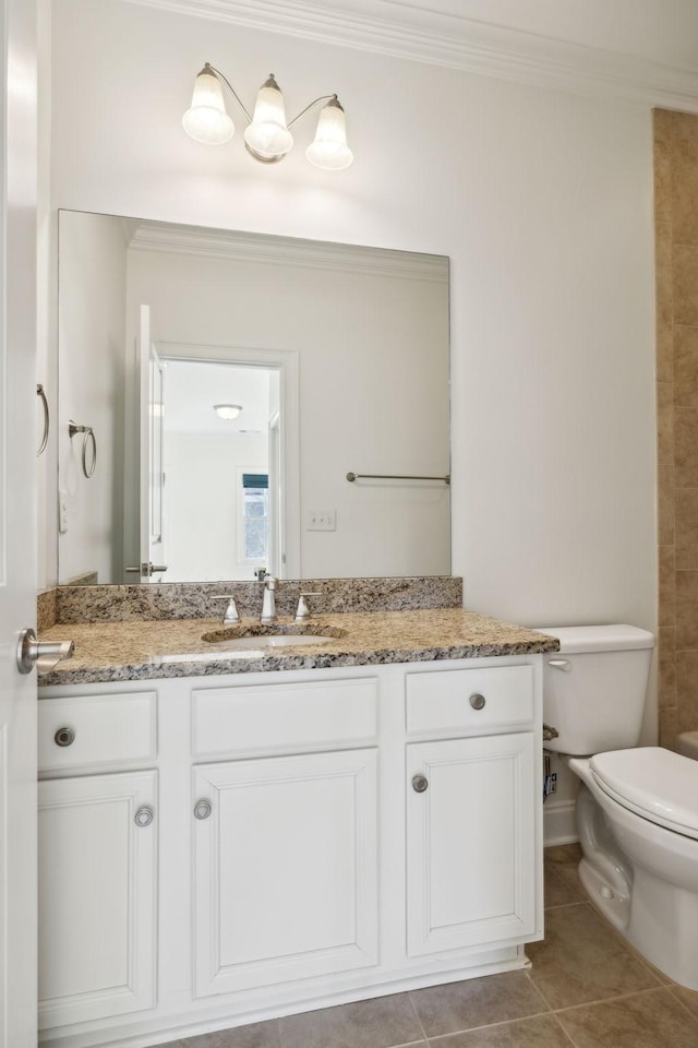 bathroom featuring toilet, ornamental molding, vanity, and tile patterned flooring