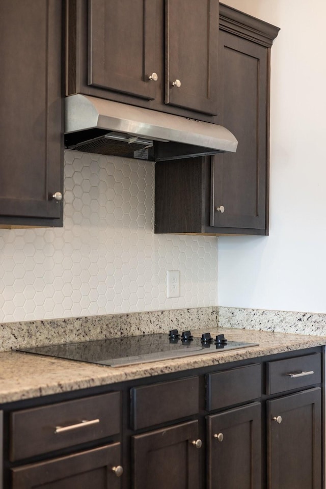 kitchen with dark brown cabinetry and under cabinet range hood