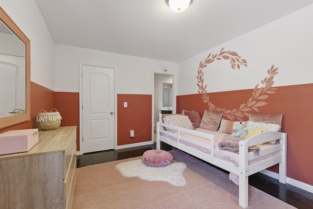 bedroom featuring baseboards and wood finished floors