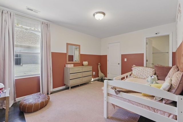 bedroom with carpet flooring, baseboards, and visible vents