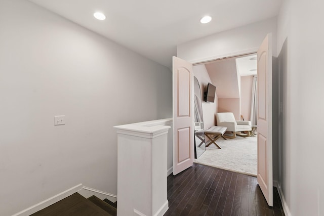 corridor featuring recessed lighting, baseboards, an upstairs landing, and dark wood-type flooring