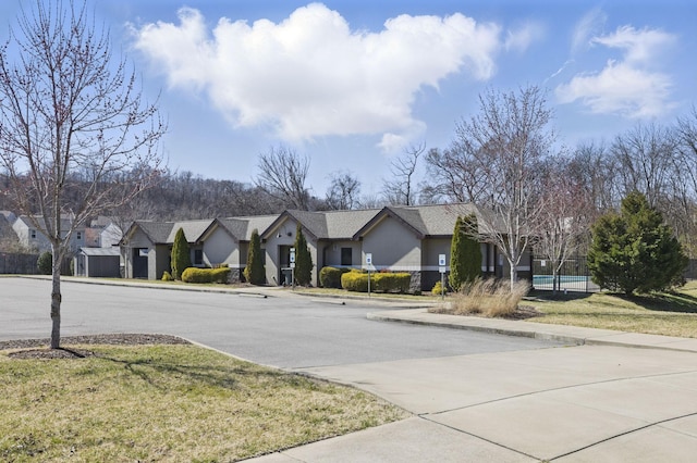 view of street with a residential view, curbs, and sidewalks