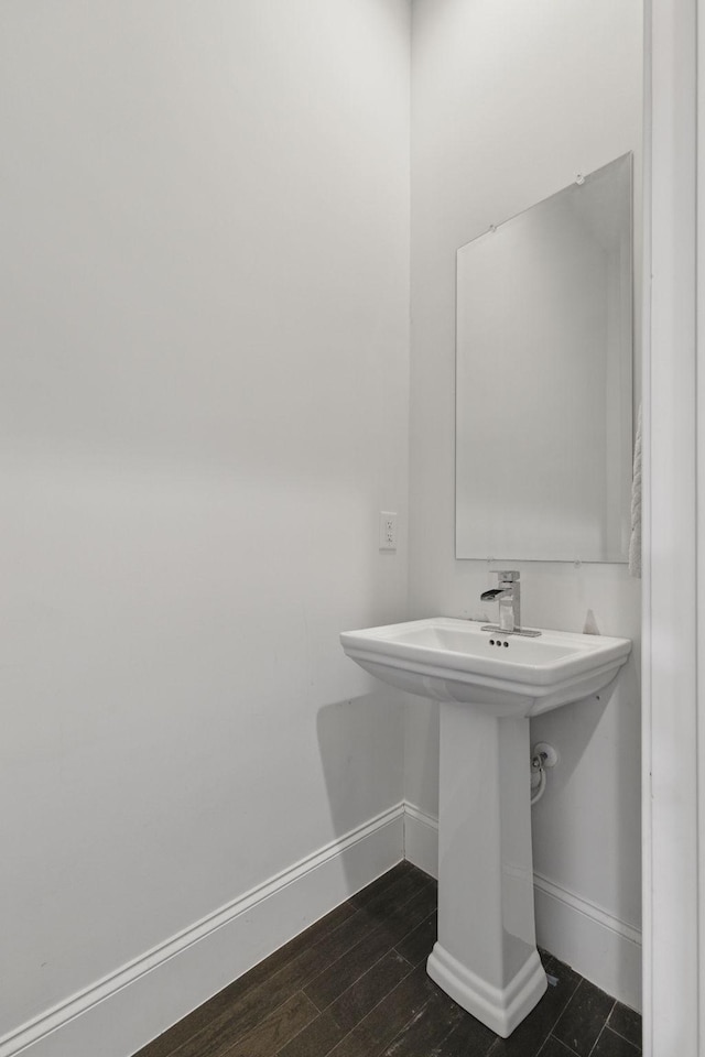 bathroom featuring wood finished floors and baseboards