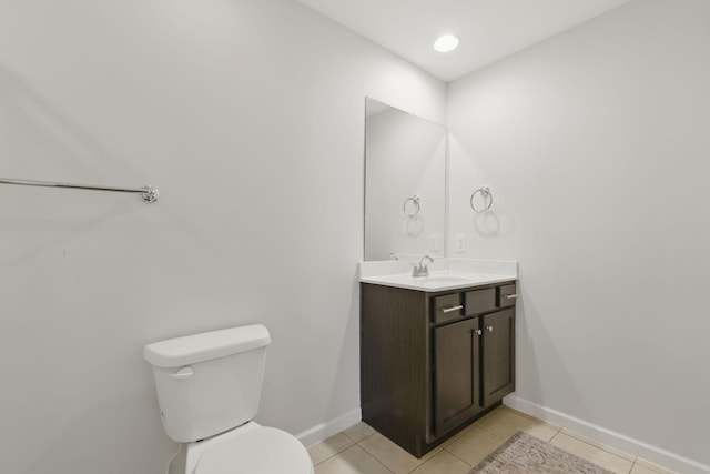 bathroom with tile patterned floors, baseboards, toilet, and vanity