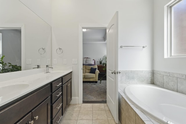 bathroom featuring tile patterned flooring, a garden tub, double vanity, ensuite bath, and a sink