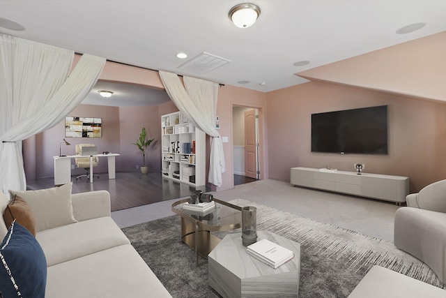 living area with recessed lighting, visible vents, and carpet floors