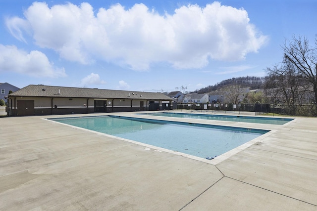 pool featuring a patio area and fence