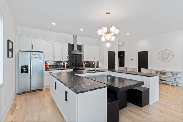 3018 Indiana Ave, Nashville, TN 37209 - kitchen featuring stainless steel fridge, wall chimney exhaust hood, a spacious island, white cabinetry, and tasteful backsplash