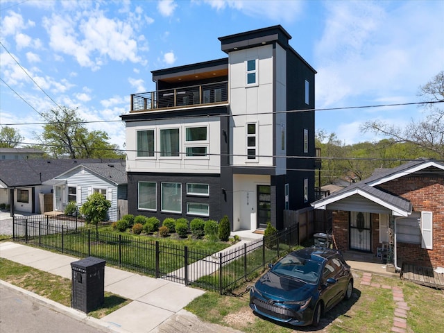 3018 Indiana Ave, Nashville, TN 37209 - contemporary home featuring a balcony, a fenced front yard, and stucco siding