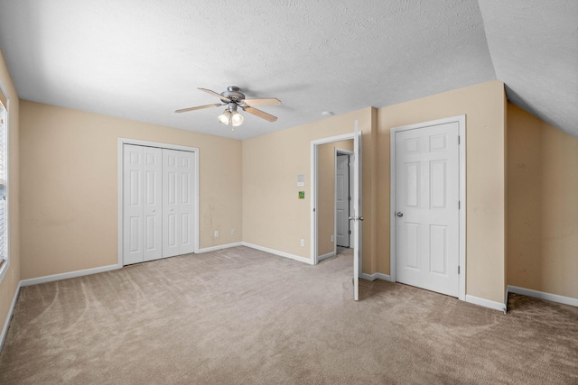 unfurnished bedroom with baseboards, carpet, and a textured ceiling