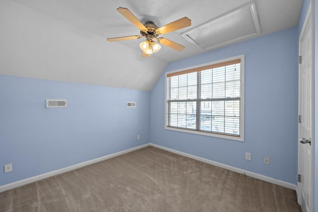 interior space featuring visible vents, attic access, baseboards, and carpet floors