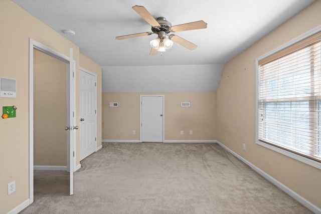 bonus room featuring vaulted ceiling, baseboards, a ceiling fan, and carpet floors