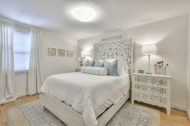 bedroom featuring wood finished floors and baseboards