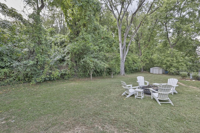 view of yard featuring an outbuilding, an outdoor fire pit, and a storage shed