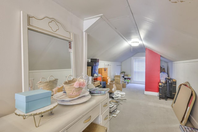 additional living space featuring lofted ceiling and carpet flooring