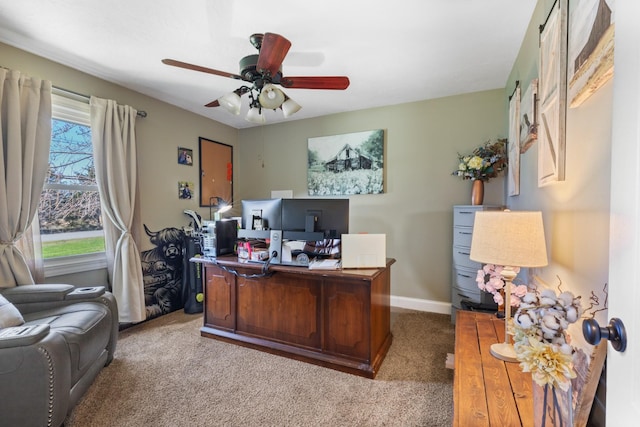 carpeted office space with a healthy amount of sunlight, baseboards, and ceiling fan