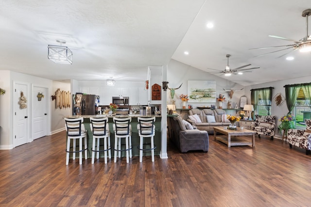 living room with lofted ceiling, a ceiling fan, dark wood-style flooring, and baseboards