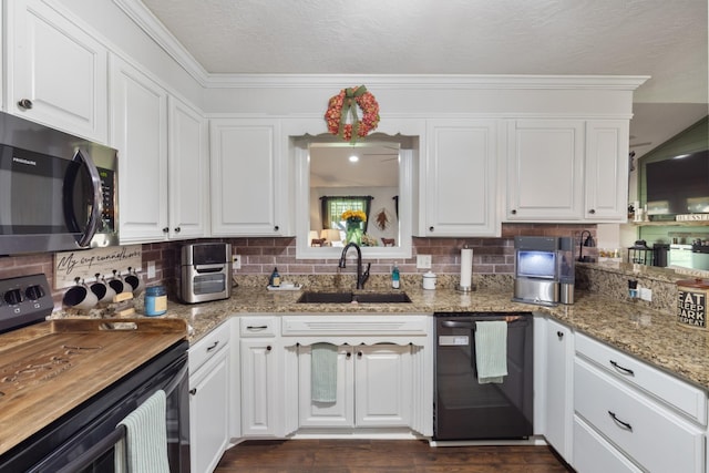 kitchen with white cabinetry, black appliances, tasteful backsplash, and a sink