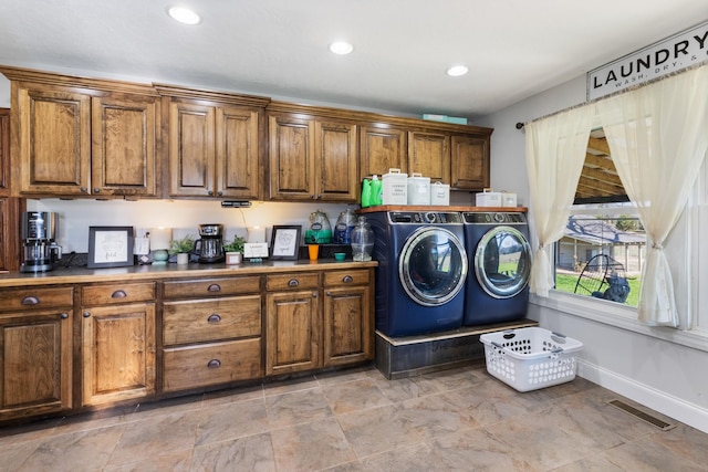 washroom featuring washing machine and clothes dryer, visible vents, baseboards, recessed lighting, and cabinet space