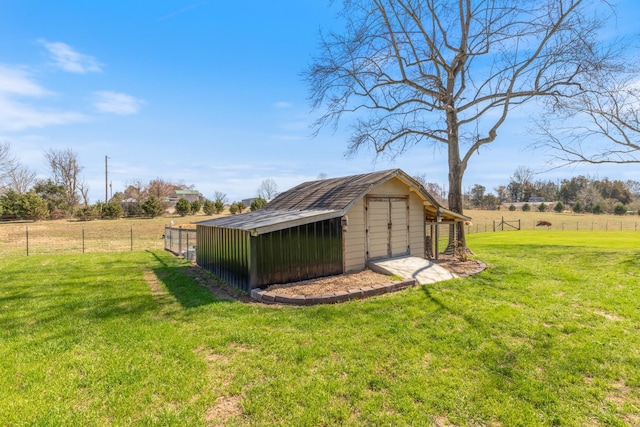 view of shed with a rural view and fence