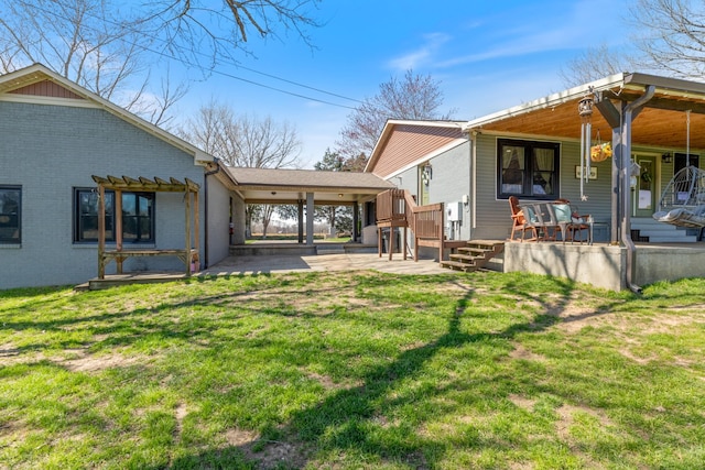 back of property featuring a pergola, a yard, covered porch, and brick siding