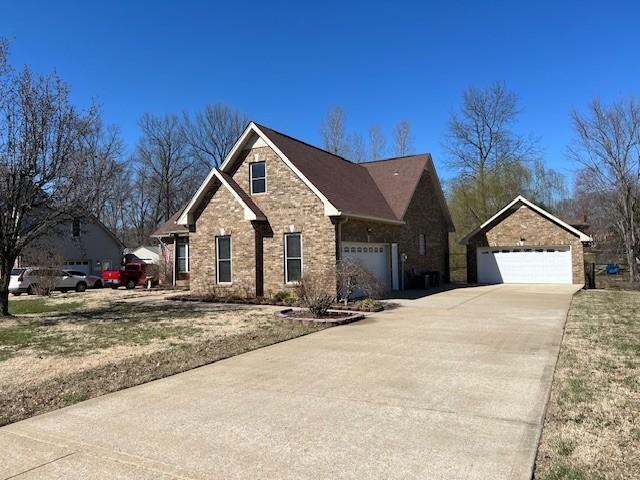 view of front of house featuring brick siding and driveway