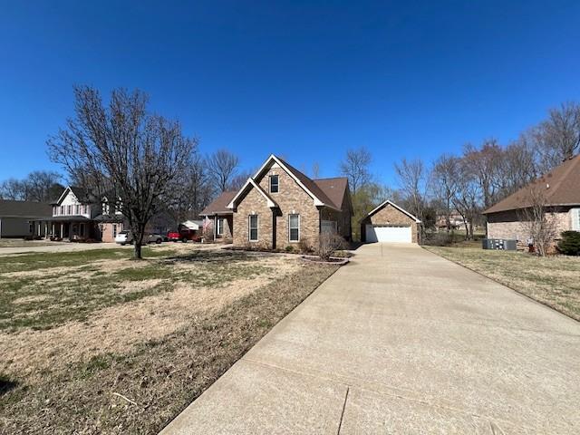 view of front of property featuring concrete driveway and a garage